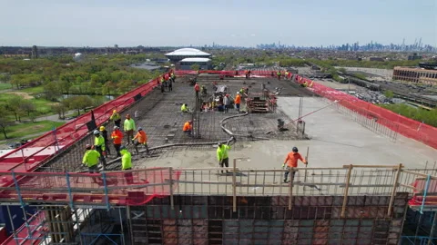 Drone pan view of Construction workers with Highrise. Progres build.4K Video stock 233589388