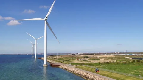 Drone panning around big windmills on the coast of Copenhagen Stock Footage 298652355