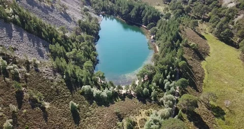 Drone panning around Green Lochan (Lochan Uaine) in Glenmore in Cairngorms N Stock Footage 169862637
