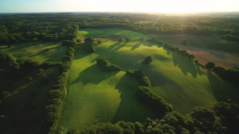 Drone panning around high above beautiful green summer meadow Video stock 298652477
