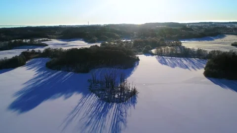 Drone panning around high over frozen lake in the countryside Stock Footage 305565126