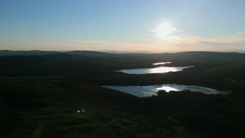 Drone panning around small lakes and evening sun, clear sky Stock Footage 241752070