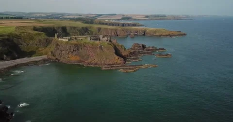 Drone panning backwards from Dunnottar Castle Aberdeenshire on sunny day Stock Footage 169862907