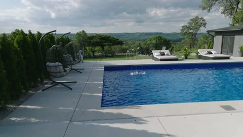 Drone panning flight over pool in yard of luxury property Stock Footage 229562549