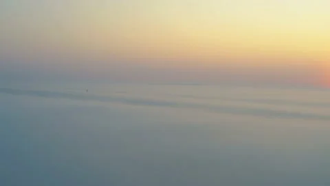 Drone panning over a big layer of heavy fog. Only a few tall buildings, con.. Video stock 236723452