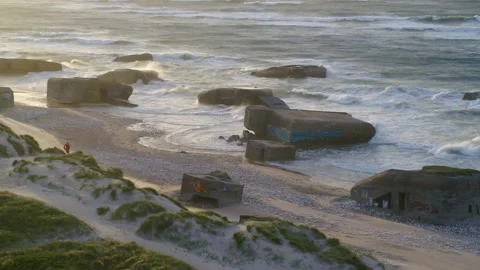 Drone panning over old World War 2 bunkers at the Danish West coast. Stock Footage 335995322