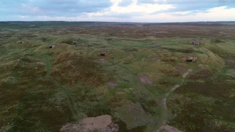 Drone panning over World War 2 bunkers in dunes at the Danish West coast Stockbeeldmateriaal 335995323