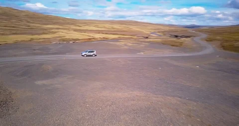 Drone panning with a passing SUV Stock Footage 101771260