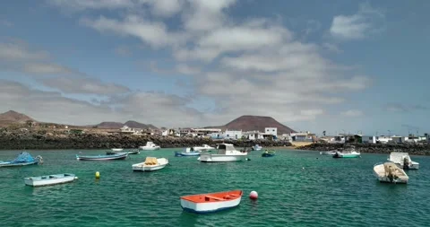 Drone panning past small boats in a harbour Stock Footage 343622378