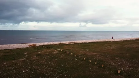 Drone panning shot of dark clouds over a beach Stock Footage 260408629