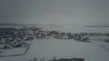 Drone panning shot snow white and gray foggy winter weather at village landscape 4k or 4k+ Resolution