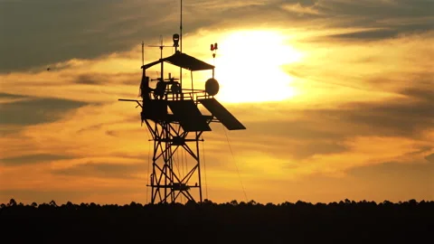 Drone Panning Silhouette View of Forest Watchtower at Sunset over Rainforest Stock Footage 340921351