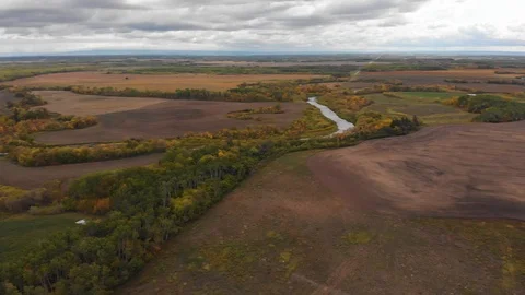 Drone panning slowly over a vast prairie landscape with the fields and trees Stock Footage 116838242