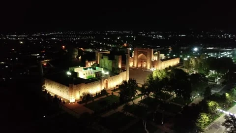 Drone panorama of the illuminated Registan complex at night, Samarkand Stock Footage 253872257