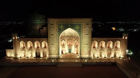 Drone panorama of the illuminated Registan complex at night, Samarkand Stock Footage 255870336