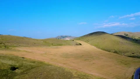 Drone panoramic view of green hills, cultivated fields, and open landscape . Stock Footage 311159192