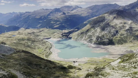 Drone panoramic view of Monte Spluga Lake - Turquoise water in Alps Stock Footage 328397813