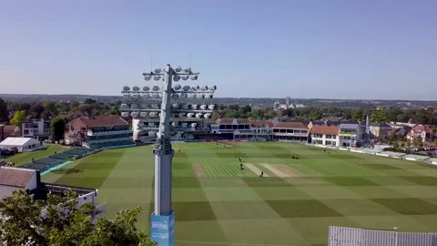 Drone pans behind floodlight Cricket ground Stock Footage 136218456