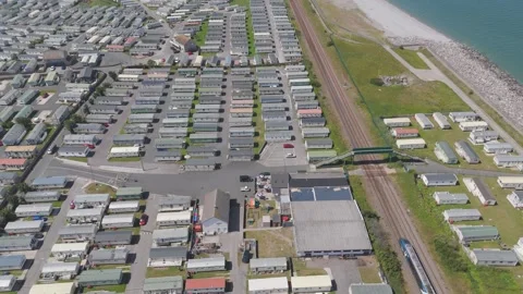 Drone pans downward following train on railway track Stock Footage 313453173