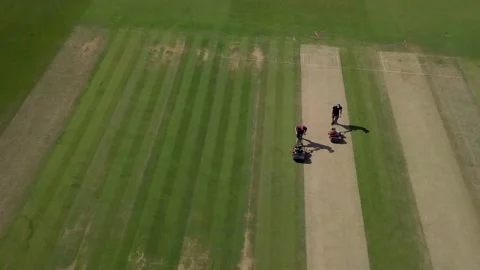 Drone pans as groundsmen cut cricket pitch Stock Footage 136218306
