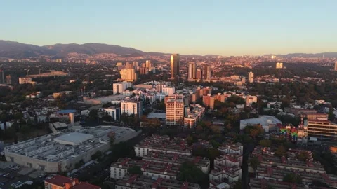 Drone parallax effect of evening in southern Mexico City, sun reflecting on Stock-Footage 304577724