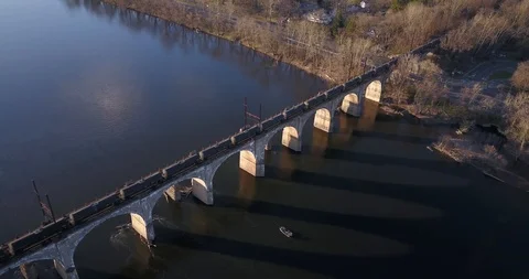 Drone parallax of freight train crossing Delaware river Video stock 127053476