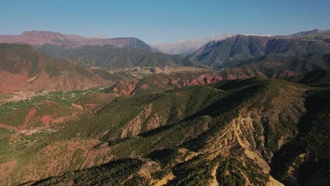 Drone parallax orbit above red ridges and High Atlas mountains in Ourika Valley Stock Footage 336761178