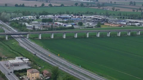 Drone parallax orbit over A1 Autogrill service area and A21 junction near Stock Footage 340603990