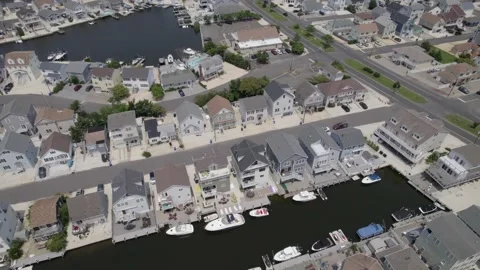 Drone parallax over large beach town boats and docks Stock Footage 160071873
