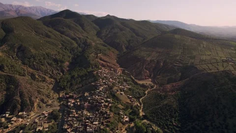 Drone parallax pullback orbit above mountain village in the Ourika Valley Stock Footage 336761386