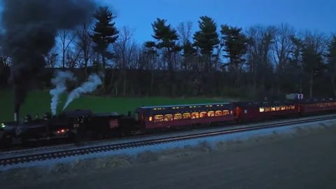 Drone Parallel Night View of a Steam Passenger Train Stopped in Farmlands B.. Stock Footage 235960581
