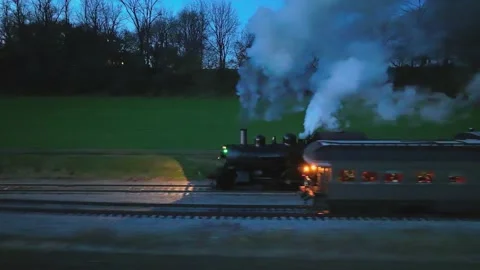 Drone Parallel Night View of a Steam Passenger Train Stopped in Farmlands B.. Video stock 235960661