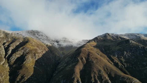 Drone pass of Five Finger Gully on Ben Nevis with snow and cloud Stock Footage 330718324