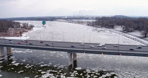 The drone passes over the ?azienkowski bridge and then over the frozen Vistul Stock Footage 107618776