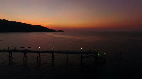 The drone passes over a pier. Shooting with drone at sunset in a bay.  Stock Footage 63116385