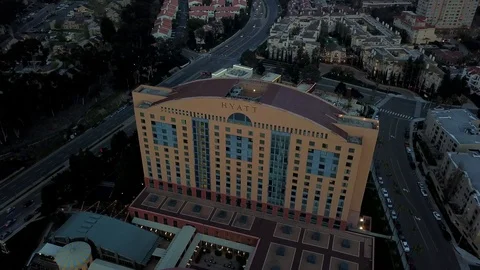 Drone passes over tall odd shaped hotel at angle with cam nearly straight down 库存影片 97182012