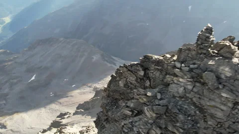 Drone passes a sharp Alpine mountain ridge Video stock 325328867
