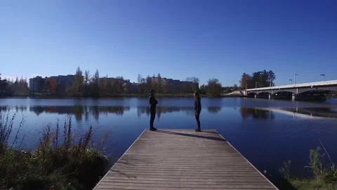 Drone Passing Between a Couple Overlooking The Lake Stock Footage 143649438