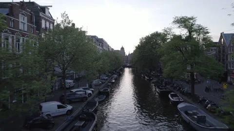 Drone passing close to trees over a canal in Amsterdam Stockbeeldmateriaal 222838775