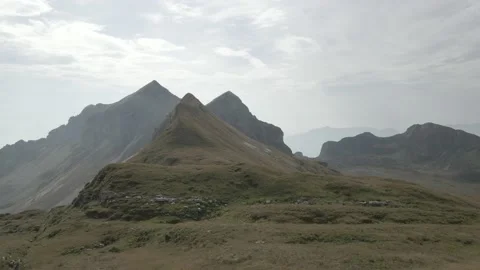 Drone passing next to grassy mountains Video stock 230164470