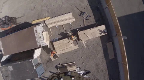 Drone Passing over Workers on Construction Site  Stock Footage 63882789