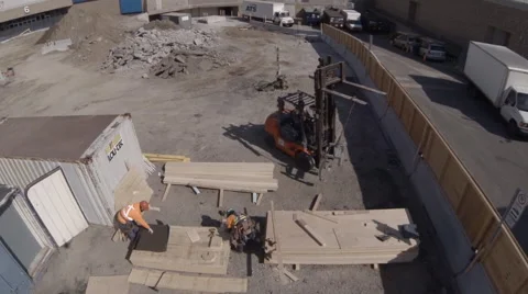 Drone Passing over Workers on Construction Site Stock Footage 63883410