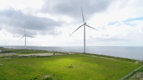 Drone passing two big wind mills at an environmental center in Copenhagen Video stock 278364328
