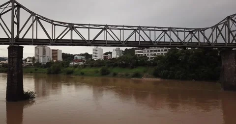 Drone passing under Ponte Aldo Pereira de Andrade on Itajaí-Açu River Stock Footage 317735602