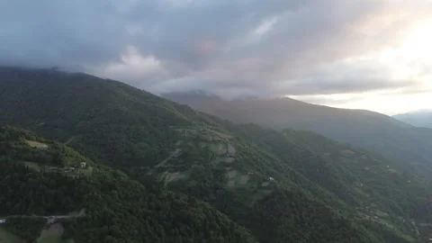 Drone Past Forested Mountains, Cloud Capped Peaks at Sunset, Georgia 스톡 동영상 337334309