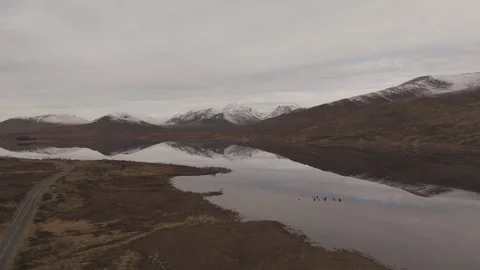 Drone Perfect Reflection of Snow-capped Mountains in Loch 4K Stock Footage 299318488