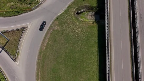 Drone perspective of a busy roundabout connecting multiple roads in suburban Stock Footage 336031268