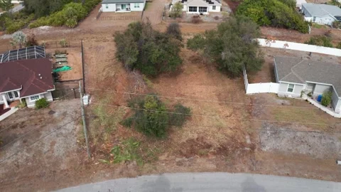 Drone Perspective of Cleared Lot with Surrounding Homes and Vegetation Stock-Footage 333939310