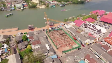 Drone perspective of crane at construction site in Samut Songkhram, Thailand Stock Footage 304441887