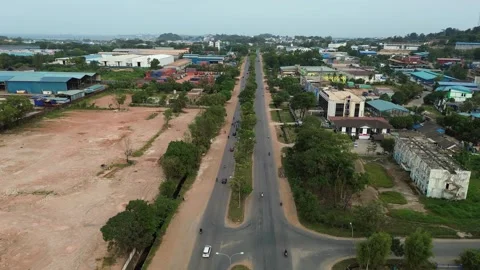 Drone perspective of an evolving urban landscape with a bustling main road .. Stock Footage 339034661
